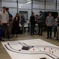 crowed of people looking at a large senior project